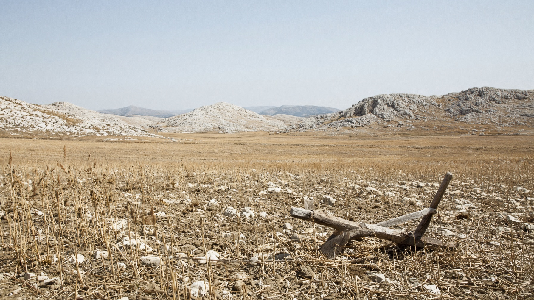 A dry stubble field and a wooden plough, seed that will not rise.